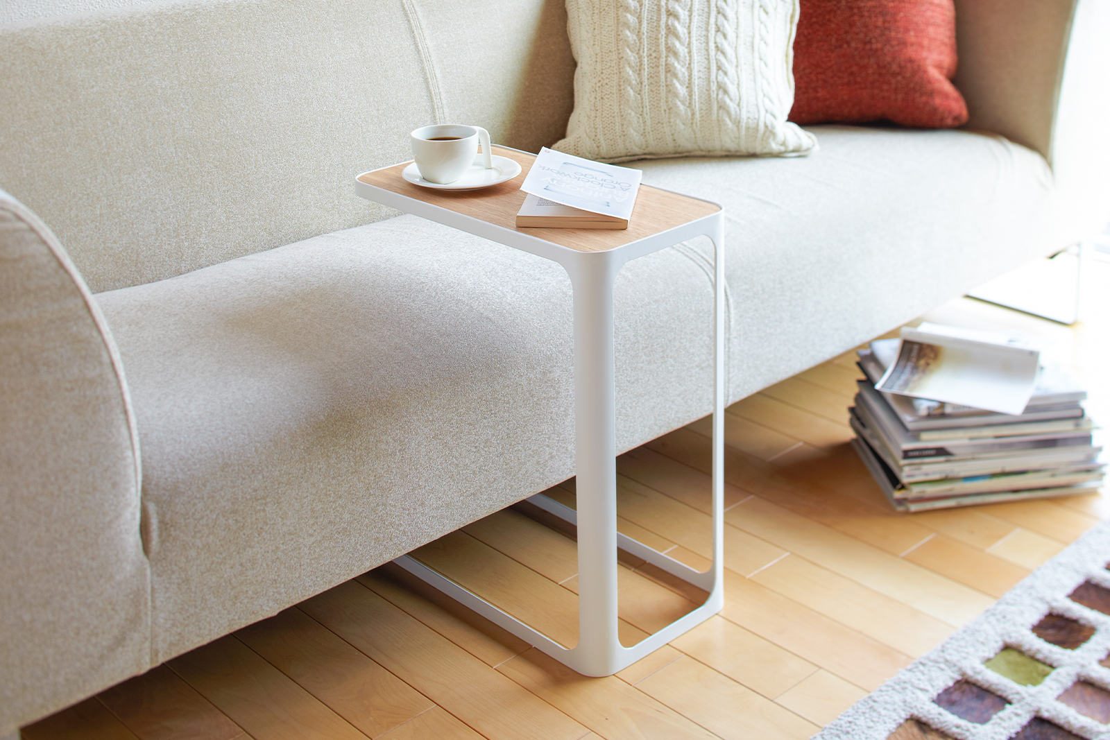 Yamazaki Home C Side Table next to a sofa. 