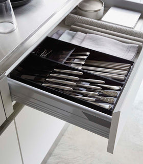 Two black Cutlery Storage Organizers holding silverware in kitchen drawer by Yamazaki Home. view 22