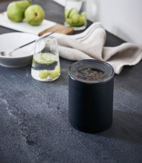 Front view of black Ceramic Canisters holding chocolate chips on kitchen counter by Yamazaki Home. view 16