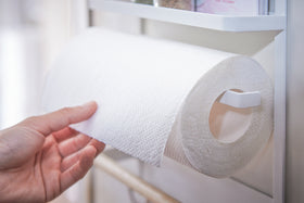 Hand removing paper towel from the Yamazaki Home Magnet Kitchen Storage Rack on a refrigerator. view 7