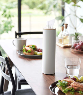 Small white Yamazaki Home Round Tissue Case on a dining table view 3