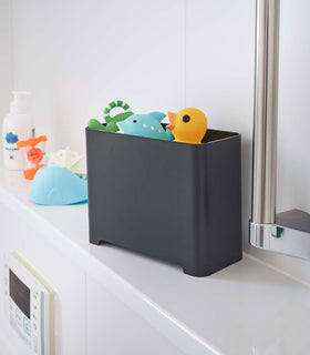 Black Yamazaki Self-Draining Bathroom Organizer filled with bath toys view 10