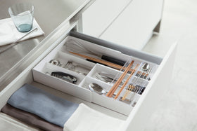 White Expandable Drawer Organizer holding kitchen utensils and silverware by Yamazaki Home. view 30