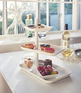 White Serving Stand displaying desserts on table by Yamazaki Home. view 3