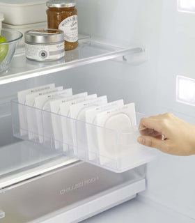 Yamazaki Refridgerator Organizer Bins being pulled out of shelf in refridgerator with food inside view 7