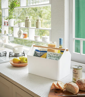 White Storage Caddy holding food items on kitchen counter by Yamazaki Home. view 3