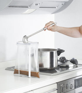 White Collapsible Bottle Dryer holding plastic bag on kitchen counter by Yamazaki home. view 5