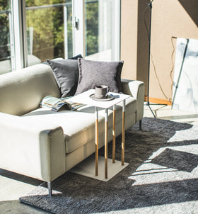 White C Side Table holding coffee cup in living room by Yamazaki Home. view 2