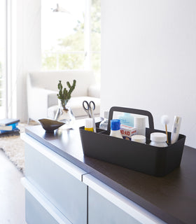 Black Storage Caddy holding first-aid items on shelf by Yamazaki Home. view 7