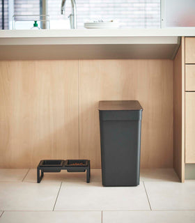 Side view of black Airtight Food Storage Container next to Pet Food Bowl in kitchen by Yamazaki Home. view 12