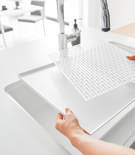 White Dish Drainer Tray with removable top in kitchen sink by Yamazaki Home. view 5