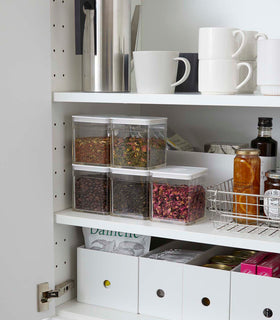 White Vacuum-Sealing Food Containers holding dry goods in kitchen cabinet by Yamazaki Home. view 2