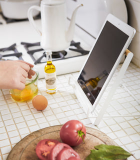 Side view of Tablet and Cookbook Stand holding tablet on kitchen counter by Yamazaki Home. view 4