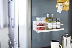 White Magnetic Storage Caddy holding spices in kitchen by Yamazaki Home. view 3