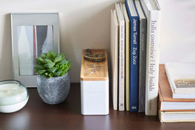 Closed White Stacking Watch and Accessory Case in between books and plants view 20