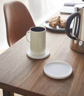 Yamazaki Home white Round Coaster on a dining table.
 view 2