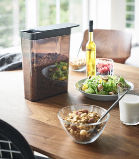 Black Storage Container holding cereal on kitchen table by Yamazaki Home. view 10