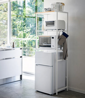 White Storage rack holding kitchen equipment in kitchen by Yamazaki Home. view 35