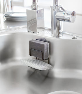 Black Sponge Holder holding sponges in kitchen sink by Yamazaki Home. view 4