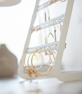 White Undershelf Hangers in kitchen holding oven mitt and bananas by Yamazaki Home. view 6