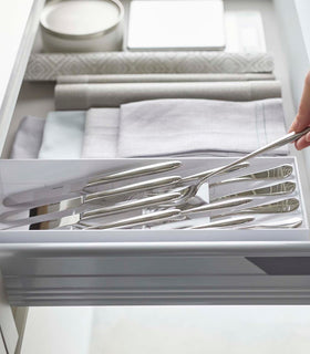 Side view of white Cutlery Storage Organizer holding silverware by Yamazaki Home. view 5