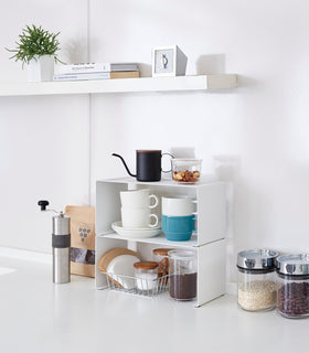 Side view of white Dish Rack containing dishware on kitchen counter by Yamazaki Home. view 3