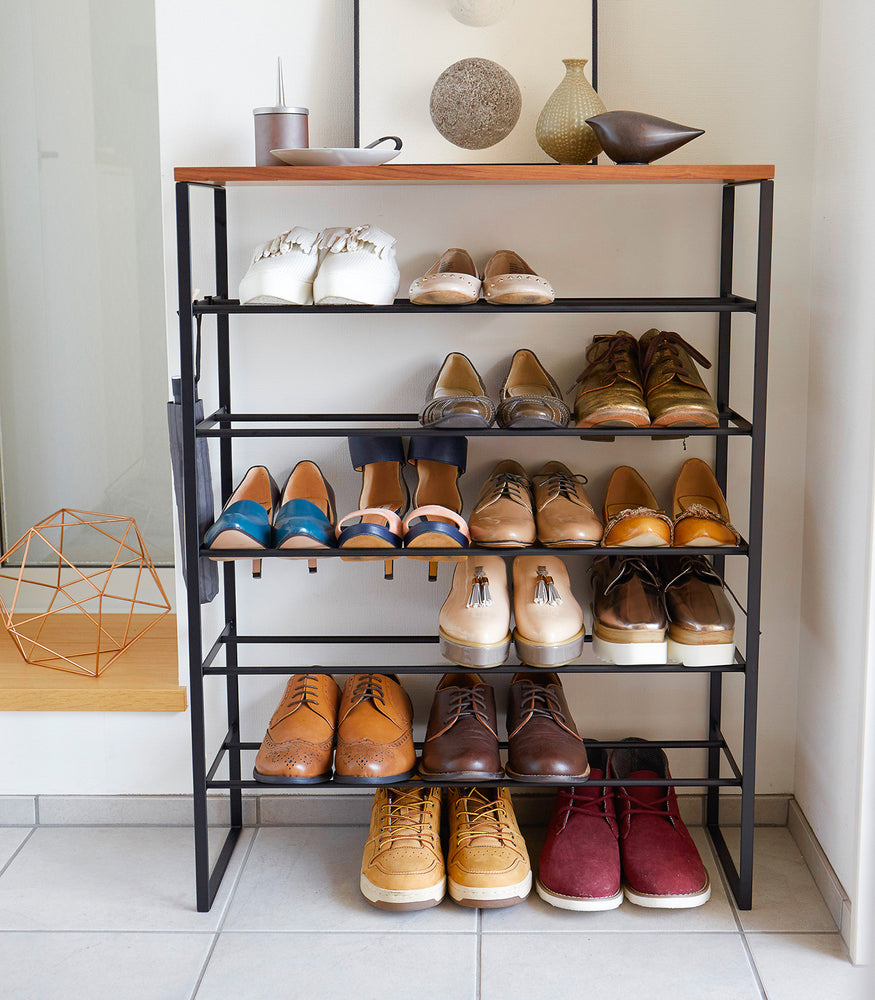 View 14 - Front view of black entryway Shoe Rack holding shoes by Yamazaki Home.