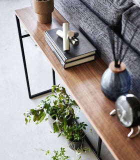 An image of the Long Console Table in black by Yamazaki Home from above, set by the back of a couch. view 13