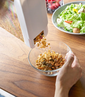 Close up of white Storage Container pouring cereal into bowl by Yamazaki Home. view 6