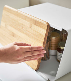 White Yamazaki Bread Box with Cutting Board Lid being opened partially with jam and spices inside view 5