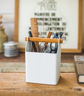 Front view of white Pencil Organizer holding glasses, rulers, and scissors by Yamazaki Home. view 3