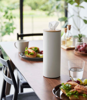 Large White Yamazaki Home Round Tissue Case on a dining table with food view 20