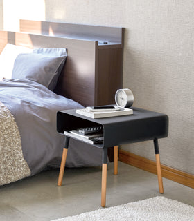 Side view of black Storage Table holding phone, books and clock in bedroom by Yamazaki Home. view 21