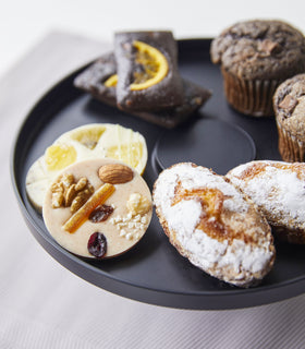 Close up view of black Stackable Serving Stand displaying desserts on white background by Yamazaki Home. view 12