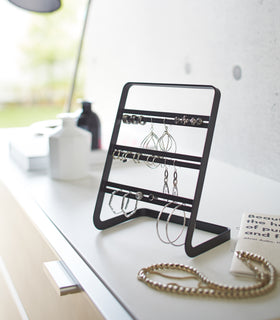 White Undershelf Hangers in kitchen holding cooking utensils by Yamazaki Home. view 10