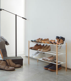 White Expandable Shoe Rack in bedroom by Yamazaki Home. view 2