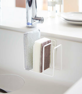 White Sponge Holder holding sponges in sink by Yamazaki Home. view 2