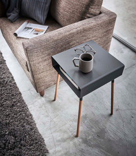 Aerial view of black Storage Table holding books, cup, and glasses in living room by Yamazaki Home. view 16