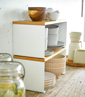 Side view of Stackable Countertop Shelves stacked togther holding dinnerware by Yamazaki Home. view 5