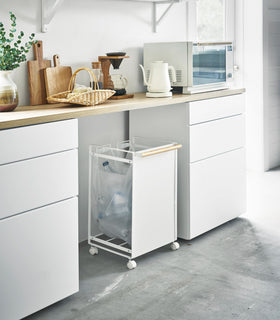 Black Grid Panel Accessory - Enclosed Shelf holding spices above kitchen stovetop by Yamazaki Home. view 2