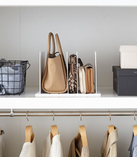 Front view of white Bag Organizer with Customizable Dividers displaying bags in closet by Yamazaki Home. view 5