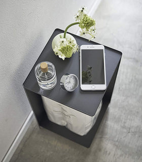 Aerial view of Black Rolling Bathroom Organizer with décor on top and holding toilet paper in bathroom by Yamazaki Home. view 10