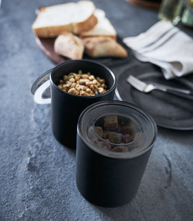 Close up aerial view of black Ceramic Canister holding sugar cubes by Yamazaki Home. view 17