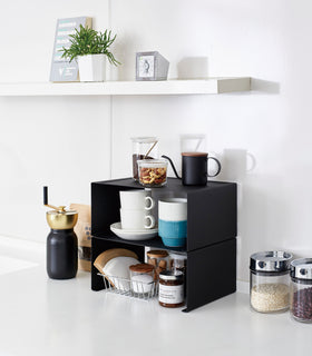 Black Stackable Countertop Shelves stacked together holding coffee brewing accessories on kitchen counter by Yamazaki Home. view 17