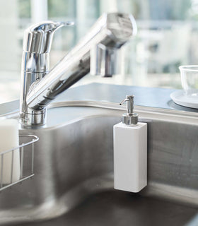 White Yamazaki Home square soap dispenser hooked on the side of kitchen sink view 5