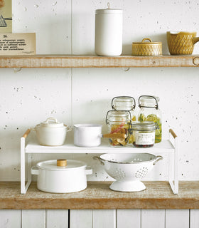 Front view of white wired organizer rack holding cups, jars, and bowls. view 4