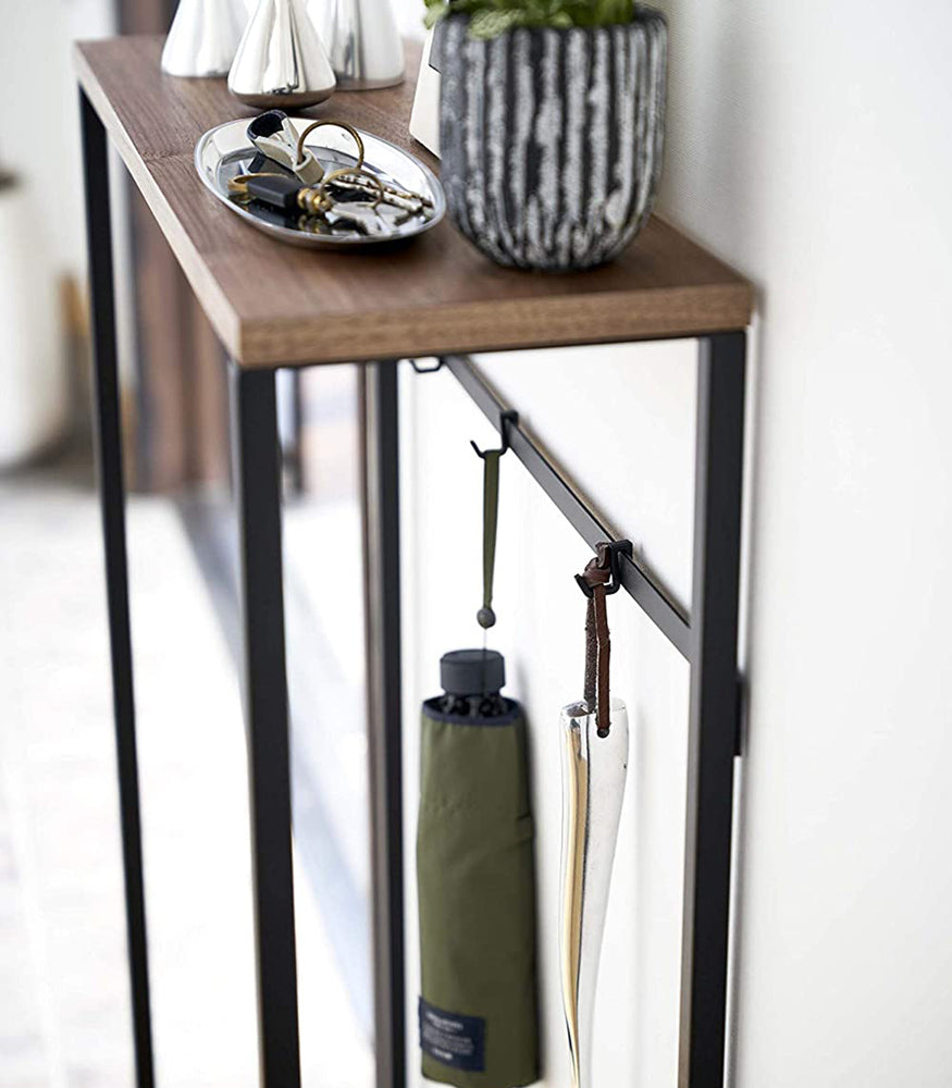 View 14 - Close up view of Narrow Entryway Console Table holding keys and umbrellas. 