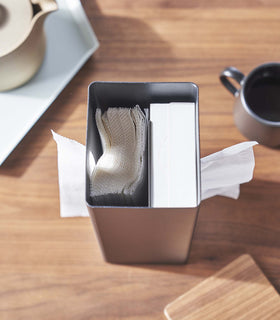 Close up of opened black Yamazaki Two-Sided Tissue Case with a tissue box on one side and paper towels on the other. view 12