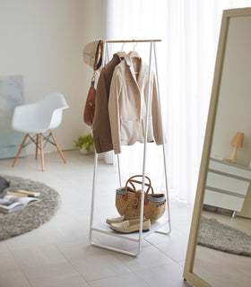 White Freestanding Coat Rack displaying jacket and accessories by Yamazaki Home. view 2